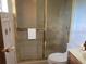 A full bathroom with a glass shower and white tiles offers clean lines at 2220 Woods Trl, Lakeland, FL 33809