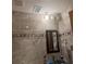 Updated bathroom featuring modern sink, mirror, and tile surround at 2220 Woods Trl, Lakeland, FL 33809