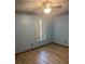 Well-lit bedroom with a ceiling fan and hardwood floors at 2220 Woods Trl, Lakeland, FL 33809