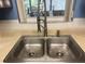 Close-up of a stainless steel, double-basin kitchen sink with pull-down faucet at 2220 Woods Trl, Lakeland, FL 33809