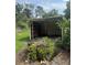 An open shed with a broon, foliage, and views of the green yard at 2220 Woods Trl, Lakeland, FL 33809