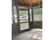 A screened-in porch with wood frame windows, with an RV visible outside at 2220 Woods Trl, Lakeland, FL 33809