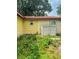 View of the home's side and rear, with a weathered exterior at 2220 Woods Trl, Lakeland, FL 33809