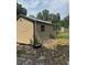 A backyard shed sits on a lot with scattered debris at 2220 Woods Trl, Lakeland, FL 33809