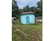 A unique blue outbuilding with porthole windows and a star decoration at 2220 Woods Trl, Lakeland, FL 33809