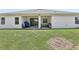 Spacious backyard featuring a covered patio, grill, and lush green grass at 229 St Thomas Dr, Mulberry, FL 33860