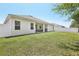 Large backyard with a covered patio and well-maintained lawn at 229 St Thomas Dr, Mulberry, FL 33860