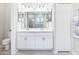 Bathroom with double sinks, quartz countertops, modern fixtures, and tiled shower at 229 St Thomas Dr, Mulberry, FL 33860