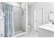 Bathroom shower with tiled walls, overhead showerhead, and glass door at 229 St Thomas Dr, Mulberry, FL 33860