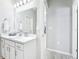 Bright bathroom with a white vanity, large mirror, and modern lighting fixtures at 229 St Thomas Dr, Mulberry, FL 33860