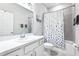 Clean bathroom with a shower/tub, gray tiled walls, and white vanity at 229 St Thomas Dr, Mulberry, FL 33860