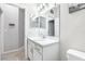 Well-lit bathroom featuring white fixtures and a decorative mirror at 229 St Thomas Dr, Mulberry, FL 33860