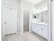 Bathroom featuring double sink vanity with white cabinets and modern fixtures, with wood-look tile at 229 St Thomas Dr, Mulberry, FL 33860