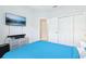 Comfortable bedroom with a mounted television and ample closet space at 229 St Thomas Dr, Mulberry, FL 33860