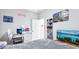 Inviting bedroom with a 'Let's Party' neon sign and wall-mounted shoe rack at 229 St Thomas Dr, Mulberry, FL 33860