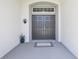 Welcoming double front door with a transom window, providing ample natural light and architectural interest at 229 St Thomas Dr, Mulberry, FL 33860