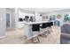 Modern kitchen featuring an island with bar seating, white cabinetry, and stainless steel appliances at 229 St Thomas Dr, Mulberry, FL 33860