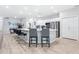 Spacious kitchen with a large island, bar stools, white cabinets, and stainless steel appliances at 229 St Thomas Dr, Mulberry, FL 33860
