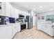 Bright kitchen with stainless steel appliances, white cabinets, and stylish backsplash at 229 St Thomas Dr, Mulberry, FL 33860