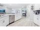 Open floor plan with kitchen island, stainless steel appliances, and seamless flow into the living spaces at 229 St Thomas Dr, Mulberry, FL 33860