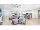 Open-concept living area showcasing wood-look flooring, a sectional sofa, and kitchen with modern appliances at 229 St Thomas Dr, Mulberry, FL 33860