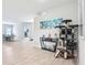 Spacious living room featuring wood-look floors, an entertainment center, and a decorative cat tree at 229 St Thomas Dr, Mulberry, FL 33860