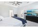 Main bedroom with ceiling fan and tray ceiling, showing entry to closet and bathroom at 229 St Thomas Dr, Mulberry, FL 33860
