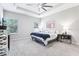 Spacious bedroom with tray ceilings, neutral colors, large windows, and soft carpet flooring at 229 St Thomas Dr, Mulberry, FL 33860