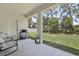 Covered patio space featuring a grill and outdoor seating overlooking the yard at 229 St Thomas Dr, Mulberry, FL 33860