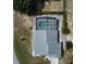 Aerial view of house with caged pool that has uniquely shaped kidney style pool at 938 Oxford Way, Lake Wales, FL 33853