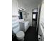 Bathroom features a modern sink, toilet and vanity, and black tile floors at 938 Oxford Way, Lake Wales, FL 33853