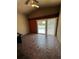 This cozy bedroom has a sliding glass door to the screened-in pool and patio at 938 Oxford Way, Lake Wales, FL 33853