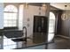 Modern kitchen features stainless steel appliances, elegant pendant lighting, and plenty of counter space at 938 Oxford Way, Lake Wales, FL 33853