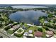 Overhead shot displays a collection of homes neighboring a large lake, emphasizing the community's scenic appeal at 212 Overlook Dr, Winter Haven, FL 33884
