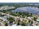 A panoramic view from above reveals lakeside homes in a peaceful neighborhood, with mature trees at 212 Overlook Dr, Winter Haven, FL 33884