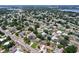 An aerial view displays the neighborhood with mature trees, and a serene lake nearby at 212 Overlook Dr, Winter Haven, FL 33884