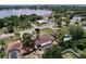 Aerial view of a home with screened-in pool, mature trees, and proximity to a lake at 212 Overlook Dr, Winter Haven, FL 33884