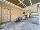 Covered back porch features ceiling fan and access to the back yard and exterior door at 212 Overlook Dr, Winter Haven, FL 33884