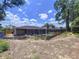 Backyard with screened-in pool area and minimal landscaping at 212 Overlook Dr, Winter Haven, FL 33884