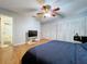 Bedroom with laminate flooring, ceiling fan, tv and multiple closets at 212 Overlook Dr, Winter Haven, FL 33884