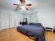 Bedroom with laminate flooring, ceiling fan, closet, vanity, and patterned curtains at 212 Overlook Dr, Winter Haven, FL 33884