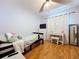 Bedroom with laminate floors, ceiling fan, tv and white curtains and vanity at 212 Overlook Dr, Winter Haven, FL 33884