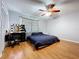 Bedroom with laminate flooring, fan, closet, vanity, and window with patterned curtains at 212 Overlook Dr, Winter Haven, FL 33884