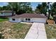 Lovely single-story home featuring a brick exterior, attached garage and an extended driveway for ample parking at 212 Overlook Dr, Winter Haven, FL 33884