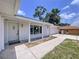 Inviting front entrance with brick pillars supporting a charming covered porch, leading to the front door and garage at 212 Overlook Dr, Winter Haven, FL 33884