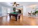 Game room featuring hardwood floors, light gray walls with white trim and view to kitchen at 212 Overlook Dr, Winter Haven, FL 33884