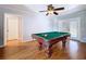 Game room featuring hardwood floors, light gray walls with white trim and a classic billiard table at 212 Overlook Dr, Winter Haven, FL 33884