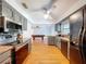 Modern kitchen with gray cabinets, granite countertops, stainless steel appliances and view to game room at 212 Overlook Dr, Winter Haven, FL 33884