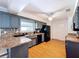 Well-lit kitchen boasts stainless steel appliances, ample counter space, and wooden floors at 212 Overlook Dr, Winter Haven, FL 33884
