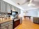 Kitchen with stainless steel appliances and stone countertops overlooks a billiards table in the living area at 212 Overlook Dr, Winter Haven, FL 33884